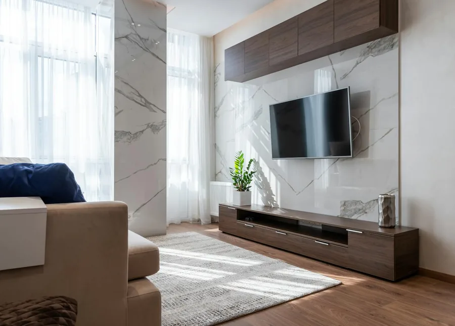Modern walnut TV unit with wall cabinets in a living room