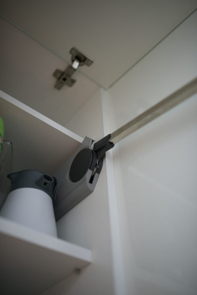 Soft-close concealed hinge and lift-up mechanism inside a modular kitchen wall cabinet